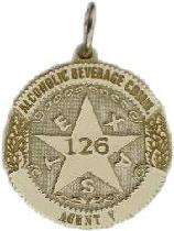 14k yellow gold custom mini-badge jewelry pendant; round badge with 5 pt 5 point five point star center in design of Texas Alcoholic Beverage Commission; also available as tie tac, lapel pin, cuff links