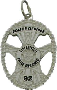 sterling silver custom mini-badge jewelry pendant; oval shaped badge design of Libertyville Police Department; also available as mini-badge tie tac, lapel pin, cuff links